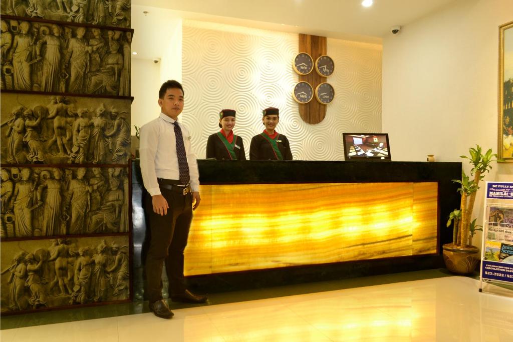 three men in suits standing behind a counter in a store at Eurotel Vivaldi Araneta in Manila