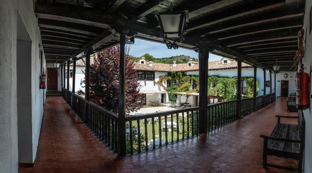 a balcony with a view of a house at Hotel Resort Cueva del Fraile in Cuenca