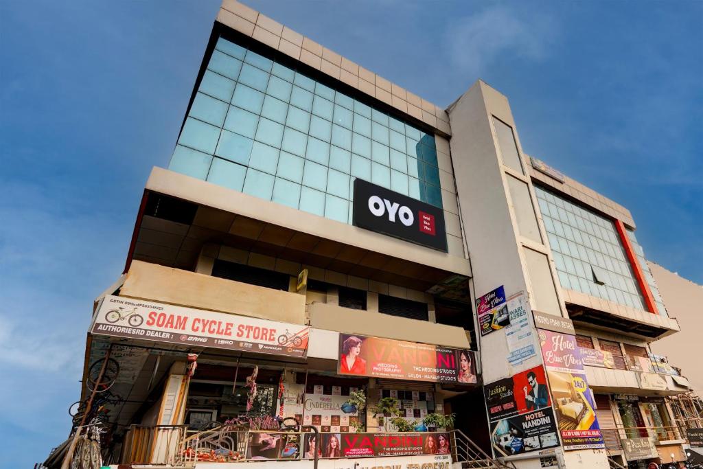 a building with an omg sign on the side of it at Hotel O Blue Vibes in Meerut