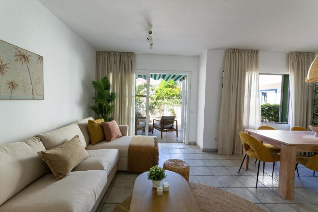 a living room with a couch and a table at Pura Vida by Maspalomas Holiday Villas in Pasito Blanco
