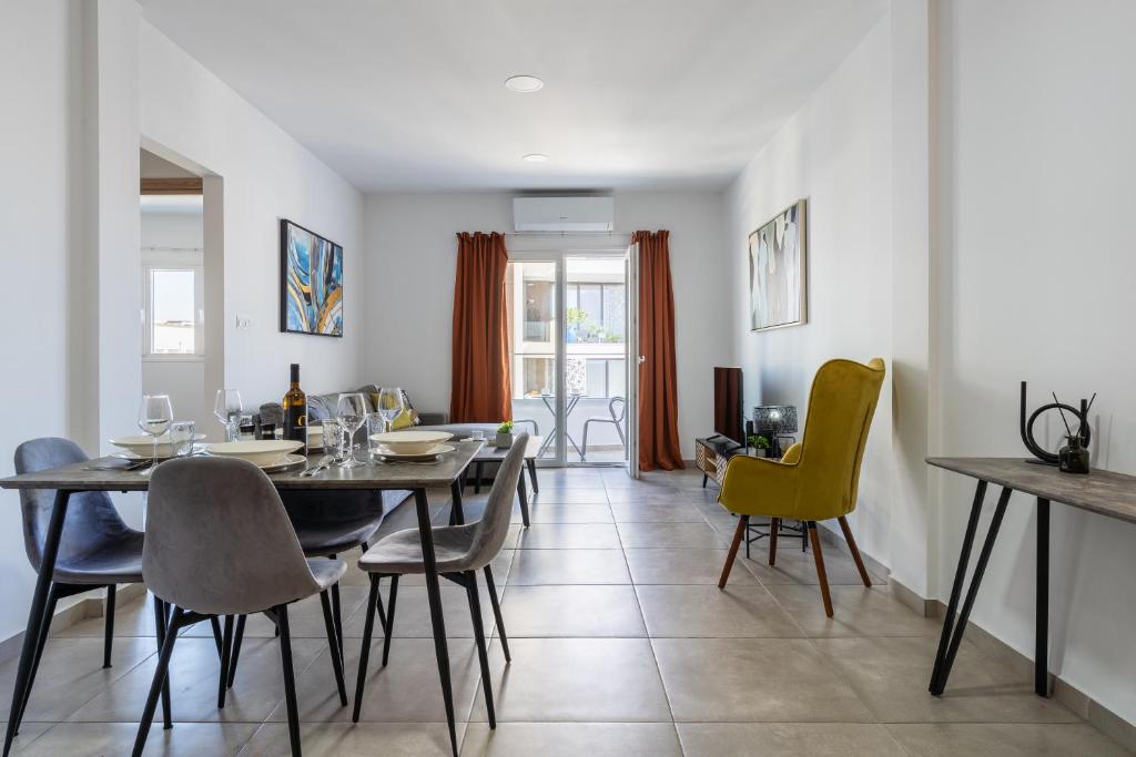 a dining room with a table and chairs at Hilltop 2-Bedroom Apartment in Larnaca