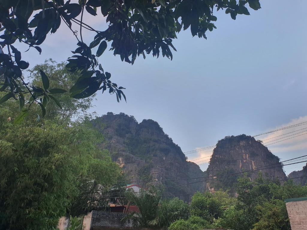 a view of the mountains with trees in the foreground at Nha Xanh Ninh Binh Homestay in Nguyên Ngoại