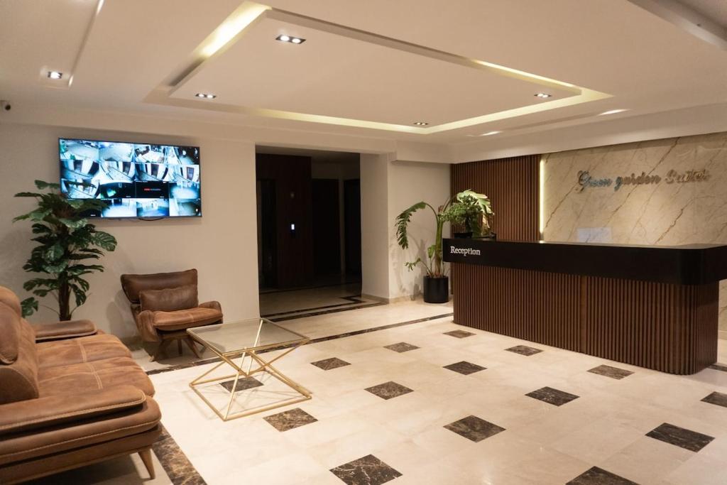 a lobby with a television and a couch and a table at Pause parfaite in El Aouina Station