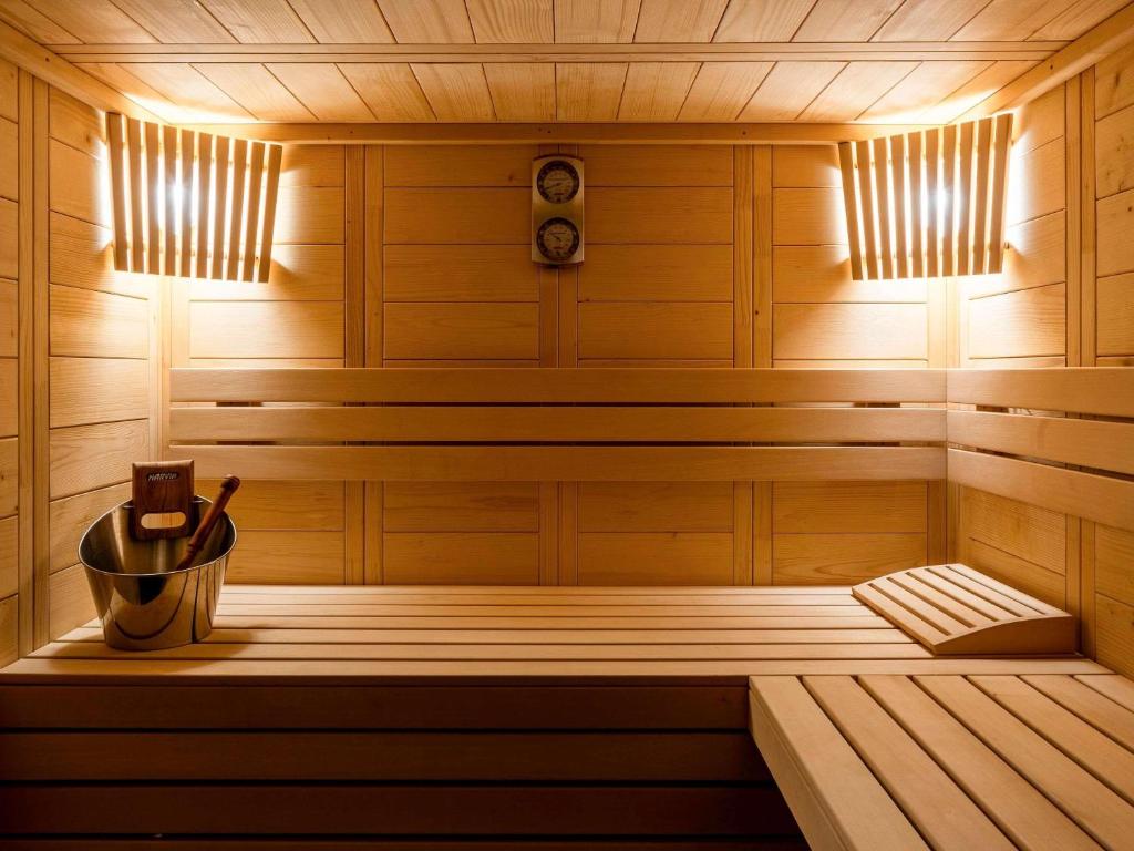a wooden sauna with a bucket in it at Mercure Sibiu Airport in Sibiu