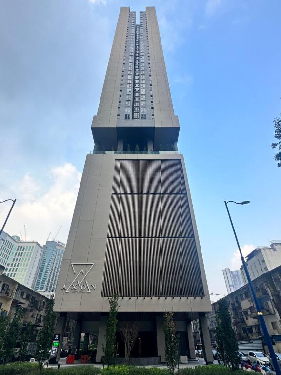 a tall building with the letter x on it at AXON Residences Kuala Lumpur in Kuala Lumpur