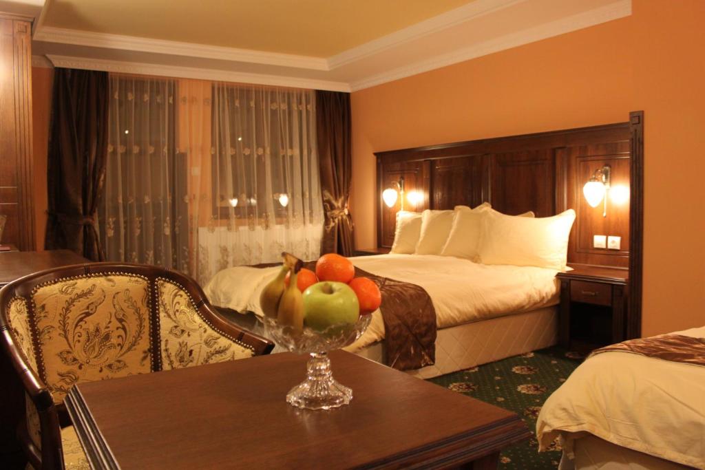 une chambre d'hôtel avec une table et un bol de fruits dans l'établissement Stoichkovata Kashta Koprivshtitsa, à Koprivchtitsa