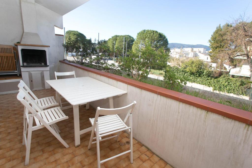 a white table and chairs on a balcony at Trilocale con terrazzino a Marcelli in Marcelli