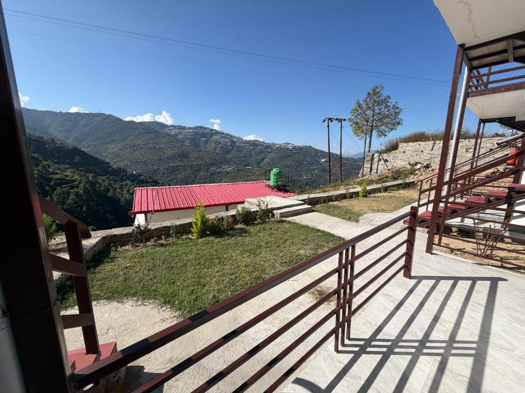 einen Balkon eines Gebäudes mit Bergblick in der Unterkunft Tathastu Resorts in Tehri-Garhwāl