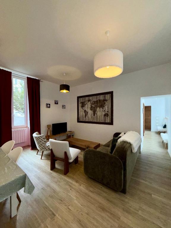 a living room with a couch and a table at Résidence Bonnecaze in Eaux-Bonnes