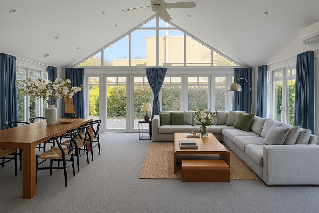 a living room with a couch and a table at Elegant Art Deco Gem Cosy 3BR Retreat in Carnegie