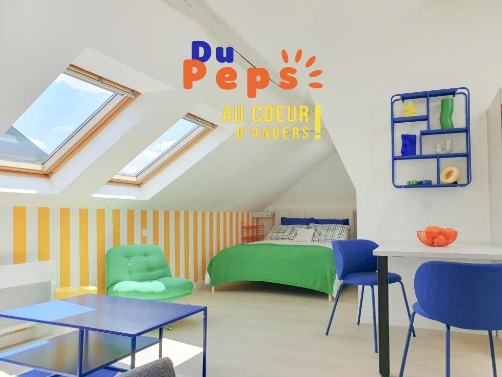 a room with a bed and chairs and a table at Du Peps au coeur d'Angers ! in Angers