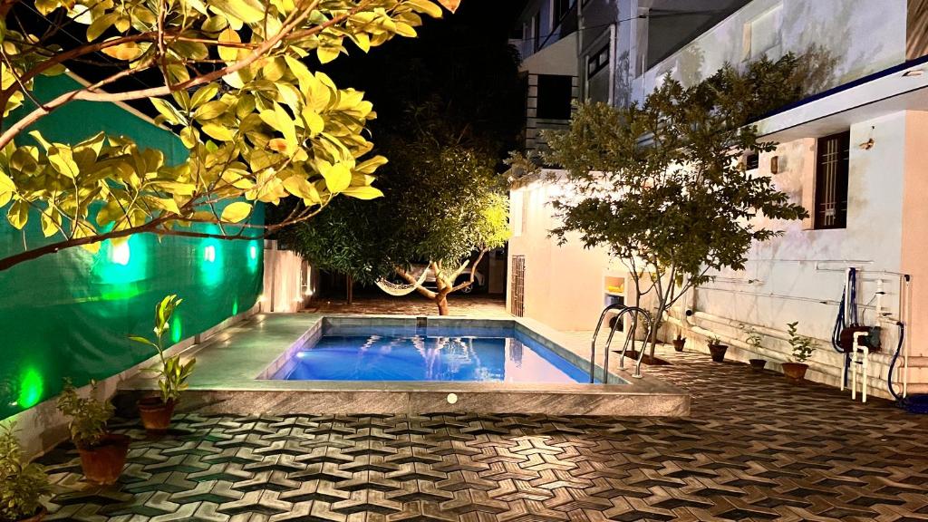 a swimming pool in a courtyard next to a building at Saro Luxury - sea view in Puducherry