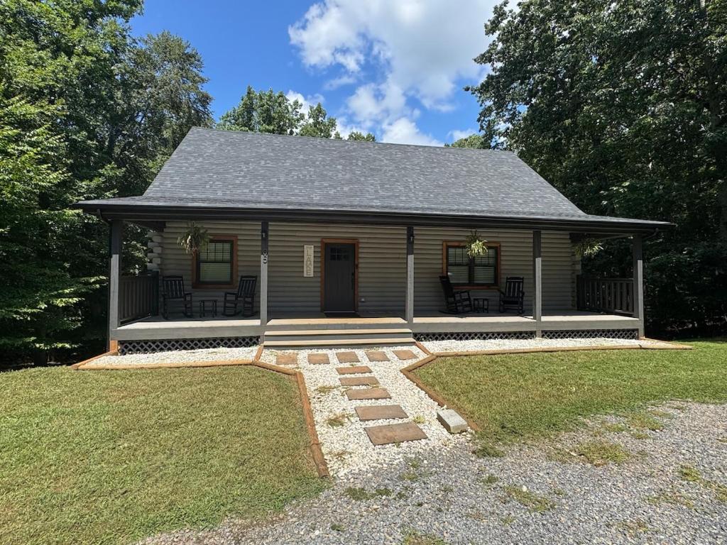a small house with a porch and a yard at Hidden gem at the lake 4 bedrooms in Moneta