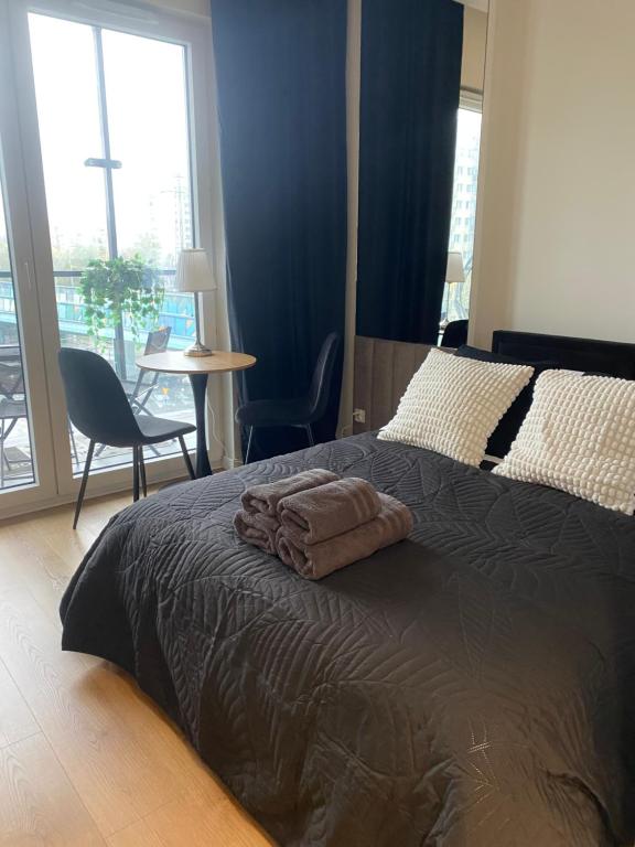 a bedroom with a bed with a towel on it at Chillout Luxury Touch Apartment - Free Parking Wola Tower in Warsaw