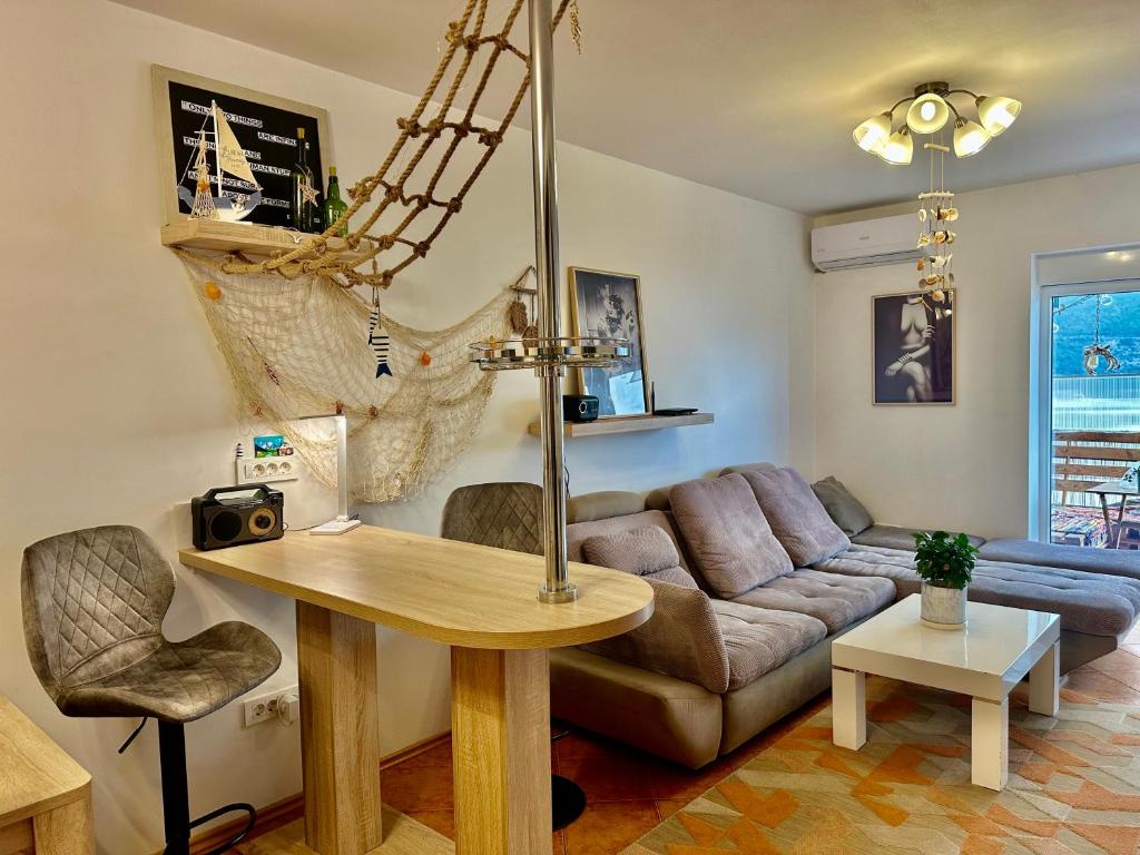 a living room with a couch and a table at Sea View Budva in Budva
