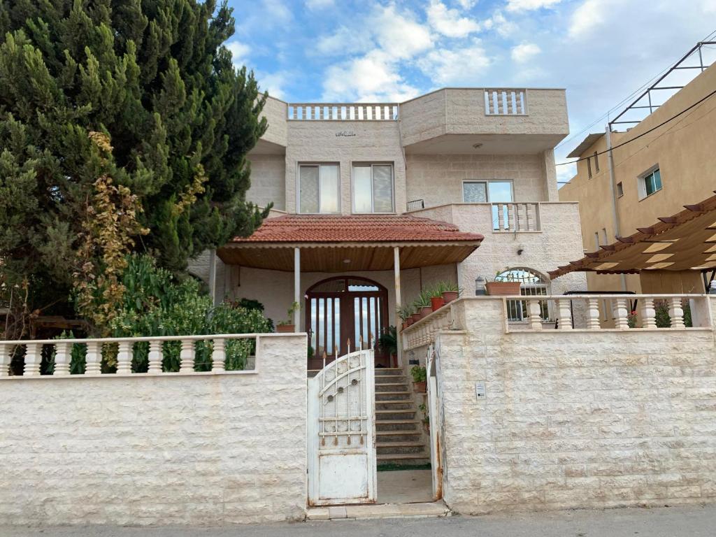 a house with a gate in front of it at Petra center suite in Wadi Musa
