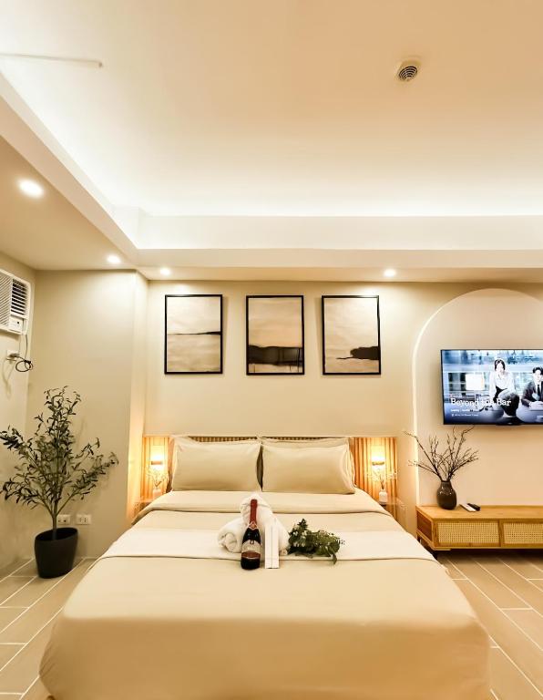a bedroom with a large bed with a tv on the wall at Exquisite Japandi 2 Venice w Grand Canal View! in Manila