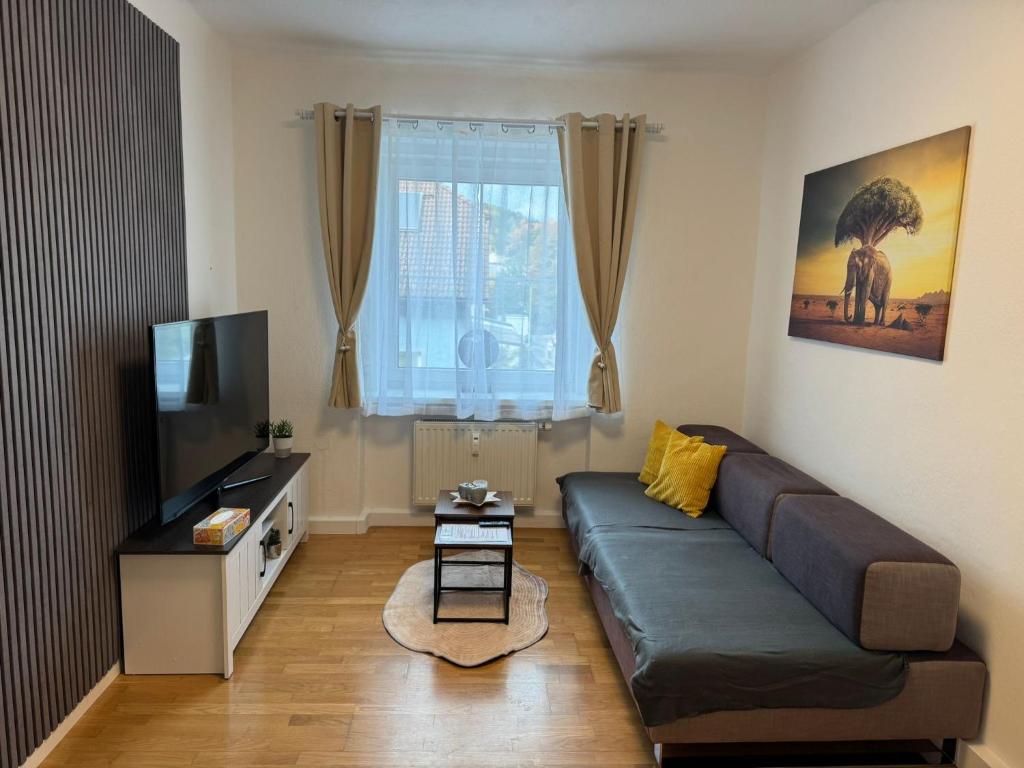 a living room with a couch and a flat screen tv at Apartment SNOW in Bruck an der Mur