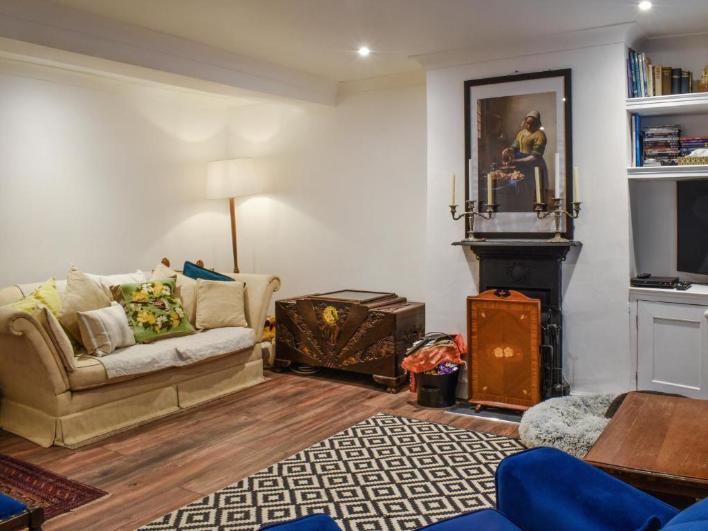 a living room with a couch and a fireplace at Coast To Coast Cottage in Cleator Moor