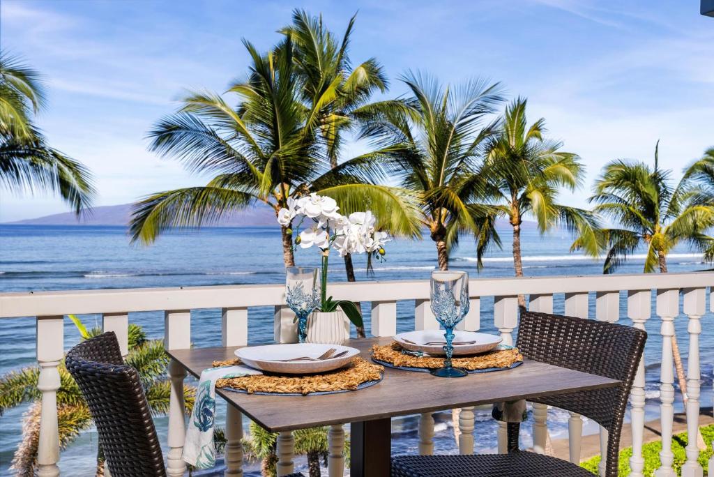 a table on a balcony with a view of the ocean at Lahaina Shores 413 · LS 413 Breathtaking Beachfront Remodeled St in Wainee