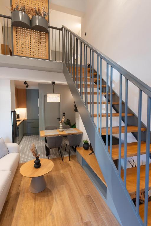 a staircase in a living room with a couch and a table at Ground Living in Volos