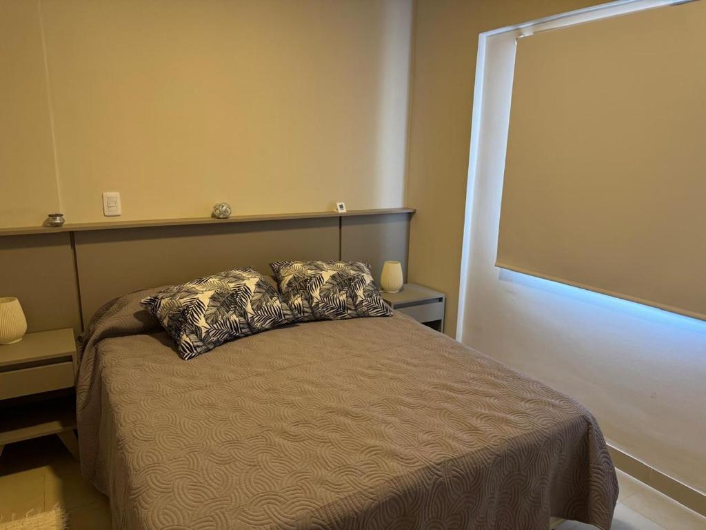 een slaapkamer met een bed met een kussen erop bij Apartamento AVITA - Centro in San Miguel de Tucumán