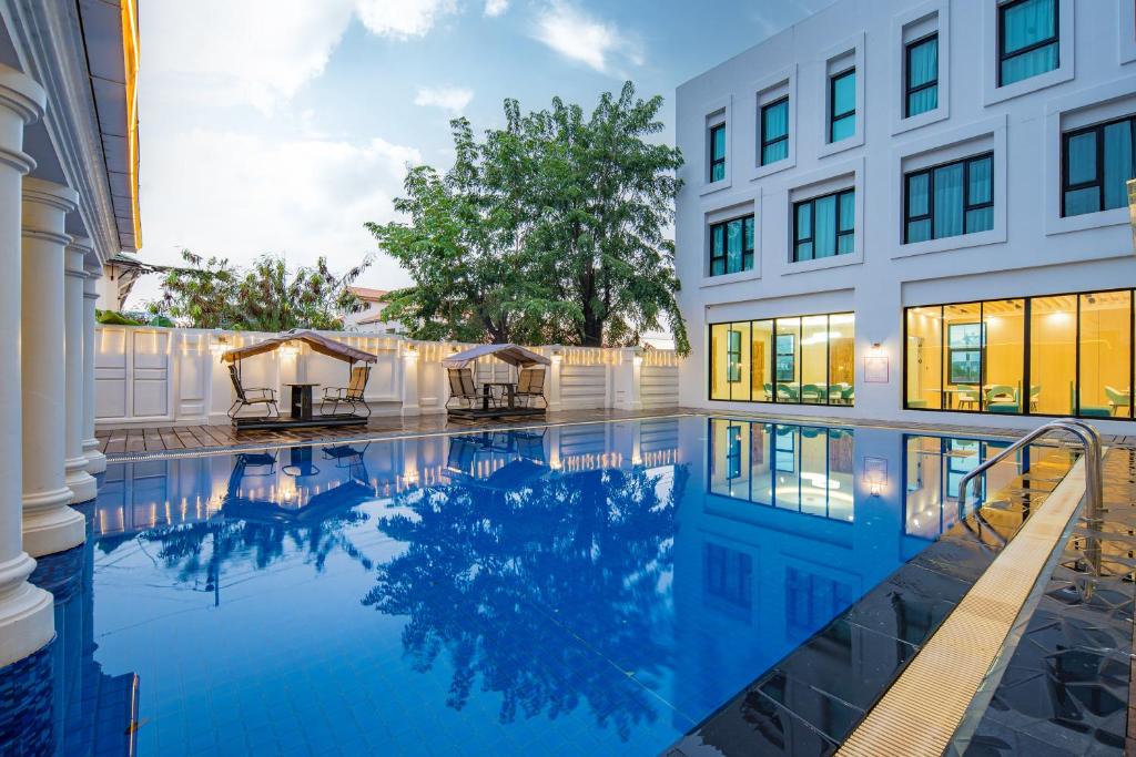 a swimming pool in front of a building at Xinmylin Boutique in Pattaya North