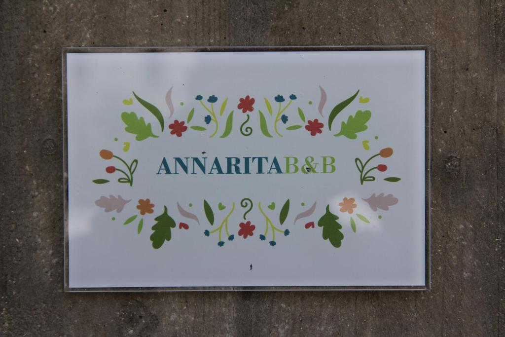 una imagen enmarcada de un diseño floral con las palabras amartifiables en Anna Rita B&B en Moie