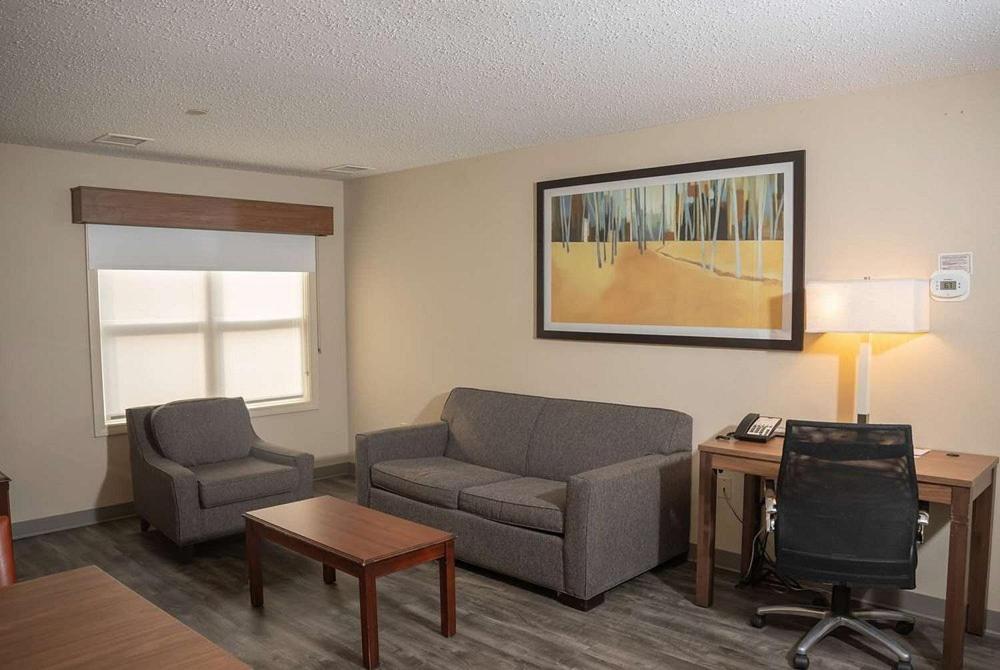 a living room with a couch and a chair at Hawthorn Suites in Erie