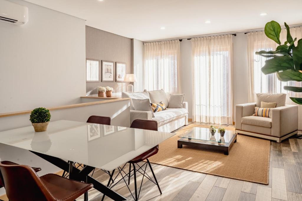 a living room with a table and a couch at LR Vintage 86 in Vila Real