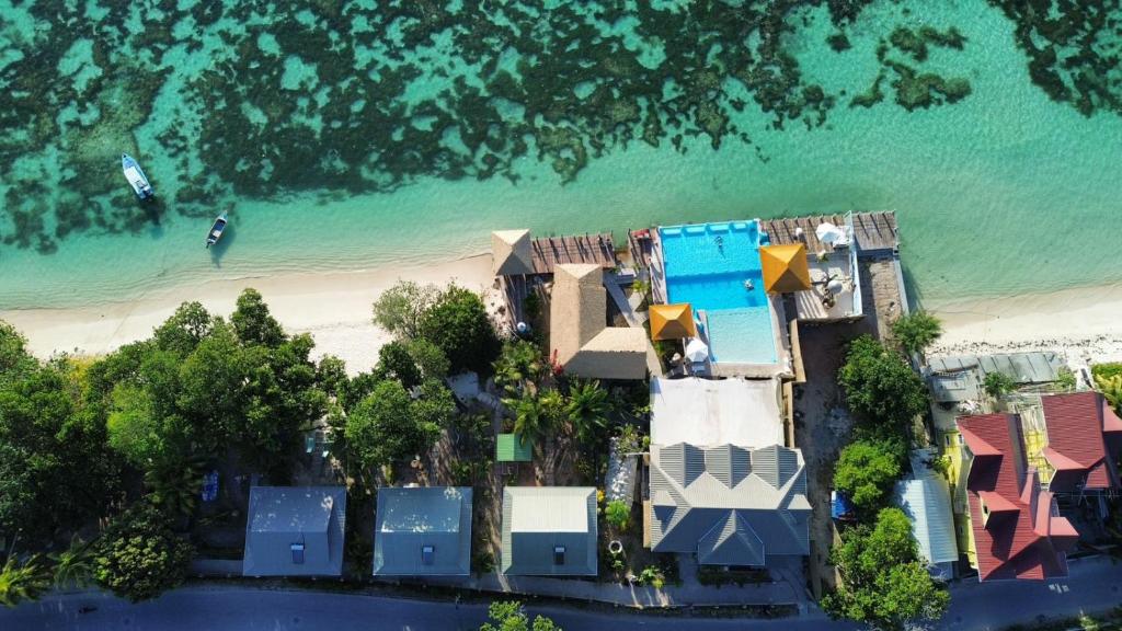 an aerial view of a resort on the beach at La Digue Luxury Beach Resort & Spa in La Digue