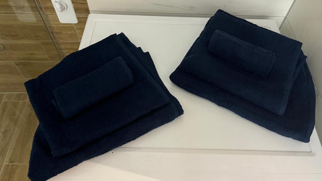 two black pillows sitting on top of a table at DreamerLux in Loznica