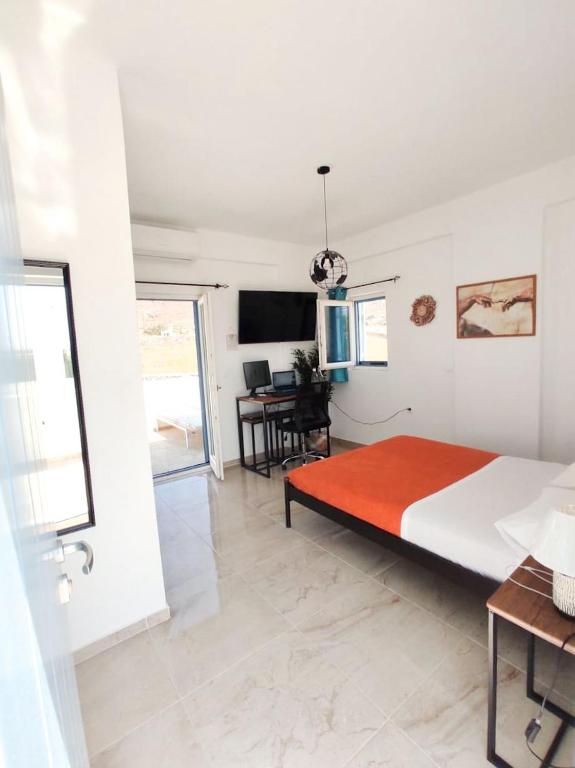a bedroom with a large bed and a table at Nympes Melody - Golden Harmony Stay in Parasporos