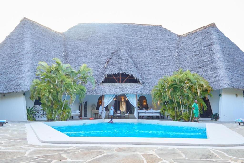 a large building with a swimming pool in front of it at Casa Madro in Malindi