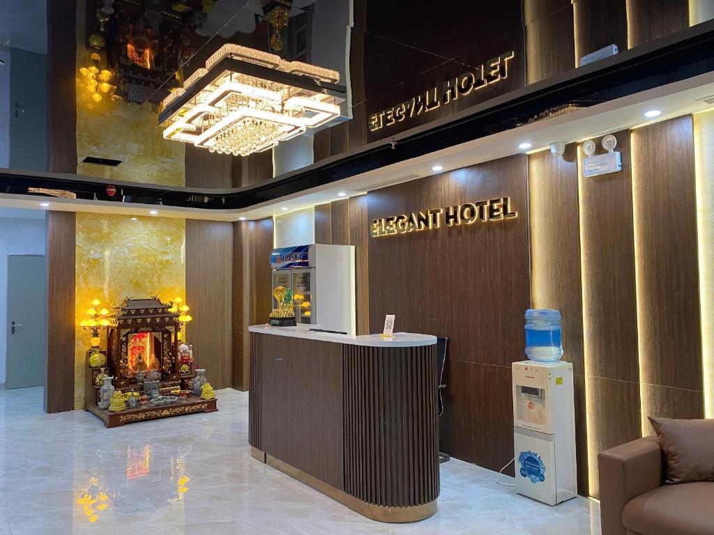 a hotel lobby with a resort hotel sign and a counter at Elegant Hotel in Hanoi
