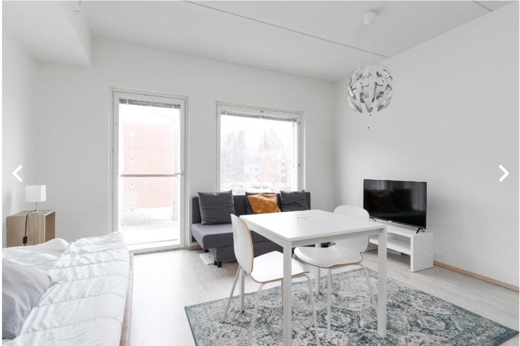 a white living room with a white table and a couch at Scandic Nest in Jyväskylä