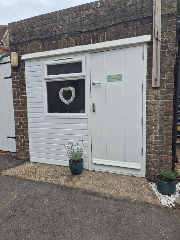 a white garage with a window and a door at 'Little Star' accommodation in Heathfield