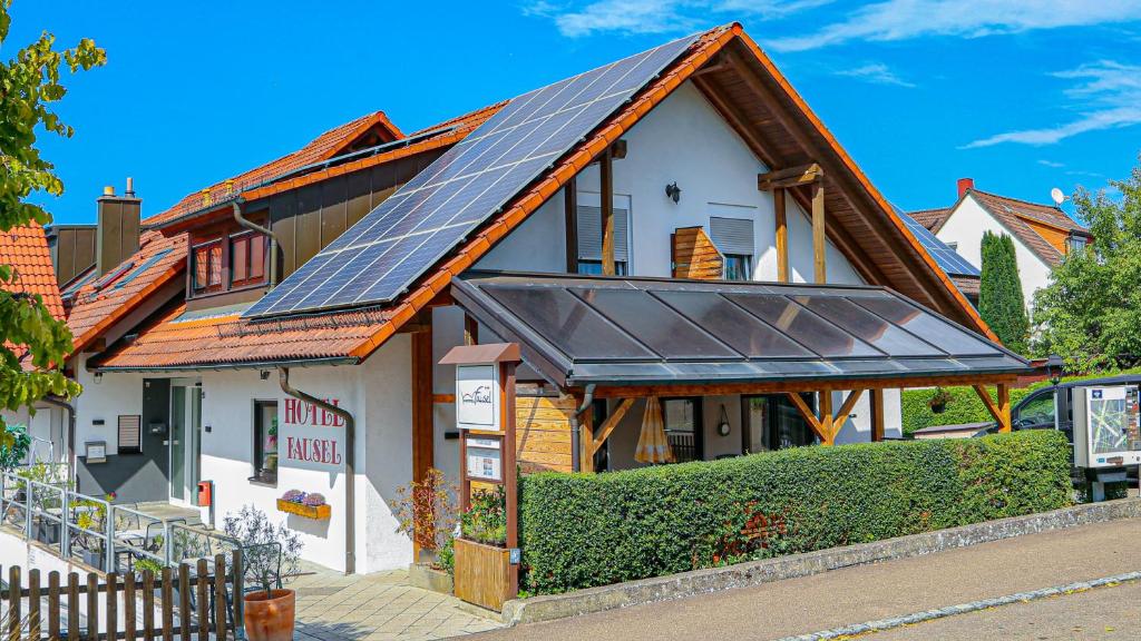 a house with solar panels on the roof at Hotel Fausel in Göppingen