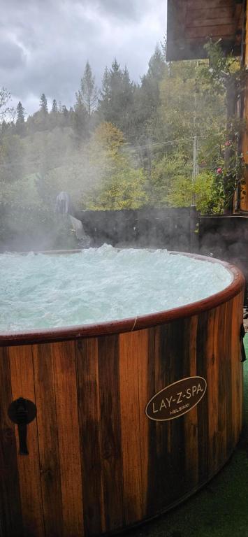 a hot tub with snow on top of it at Mój Domek z kominkiem i jacuzzi na wyłączność in Wisła