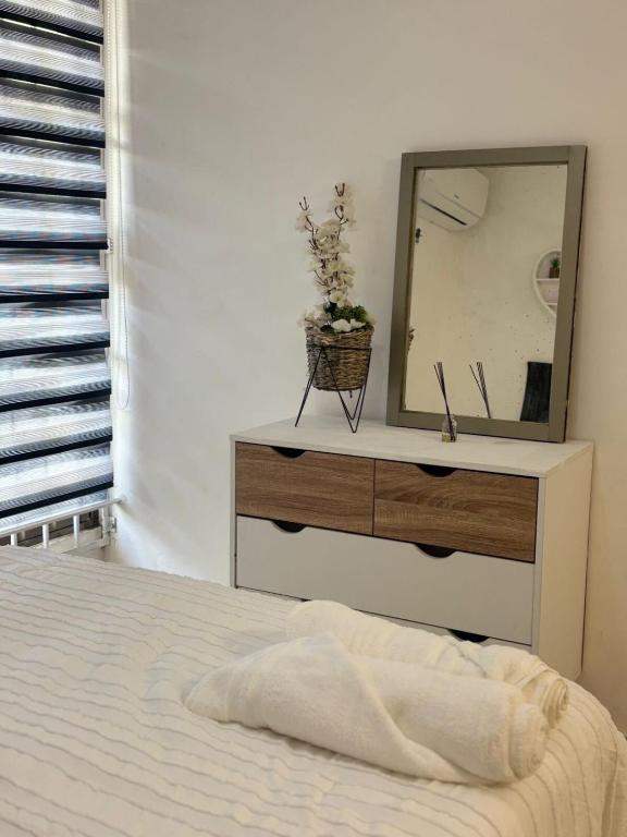 a bedroom with a dresser with a mirror on it at The Room Veracruz, super location in Veracruz