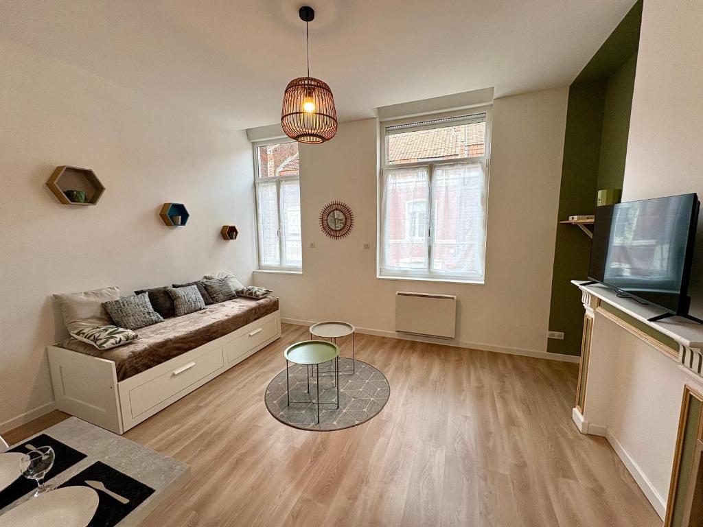 a living room with a couch and a table at Charmant Studio - Centre Douai - Netflix - 2 pers in Douai