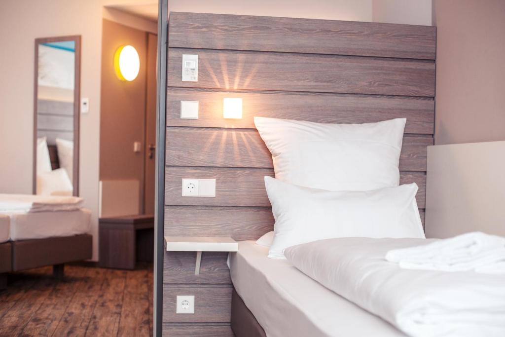 Ein Bett oder Betten in einem Zimmer der Unterkunft Tulip Inn München Messe