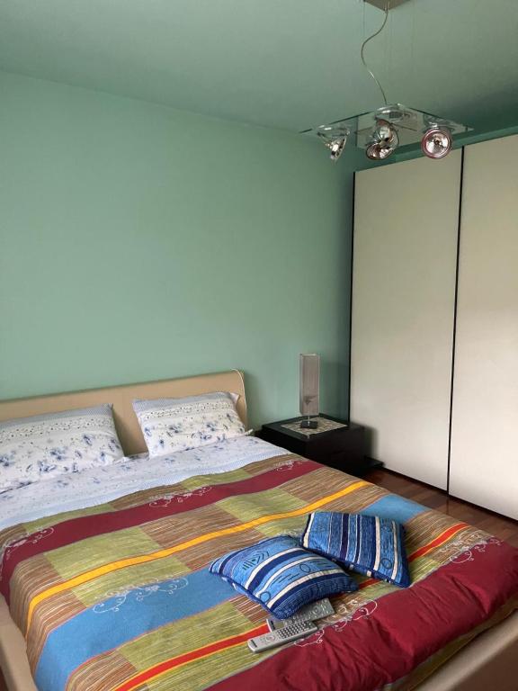 a bedroom with a bed with a colorful blanket on it at Relax a Saint-Christophe in Saint-Christophe