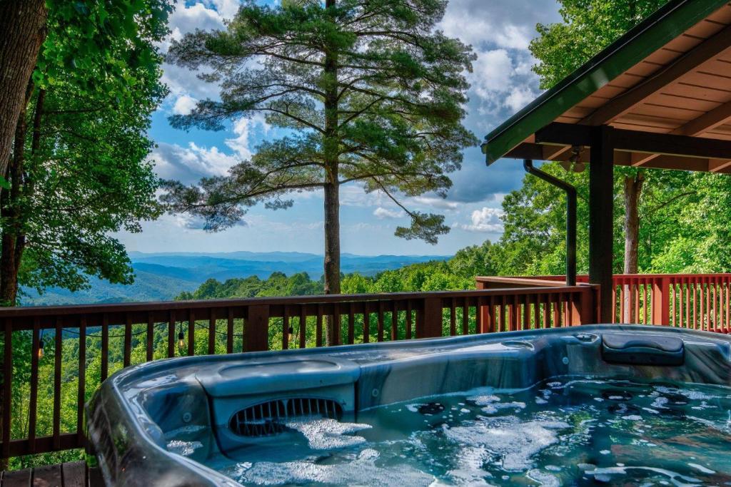 a jacuzzi tub on the deck of a house at 1 Sublime View in Boone
