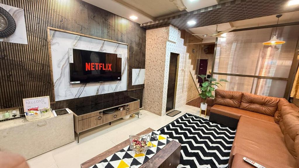 a living room with a television and a couch at Row House Near US Consulate BKC & NMCC in Mumbai