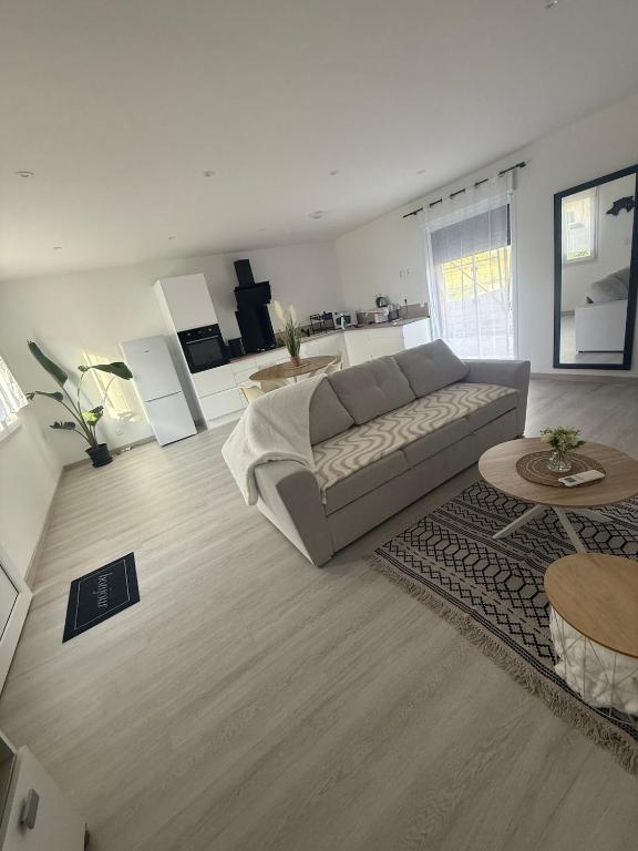 a living room with a couch and a table at Évasion détente in Heiltz-le-Hutier