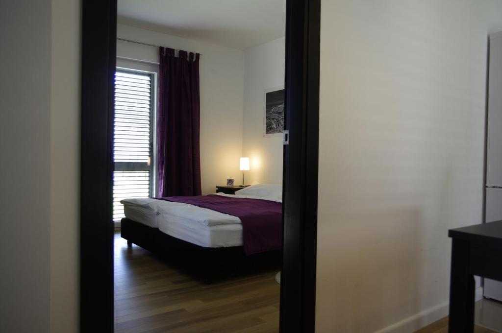 Postel nebo postele na pokoji v ubytování Apartments Santis10