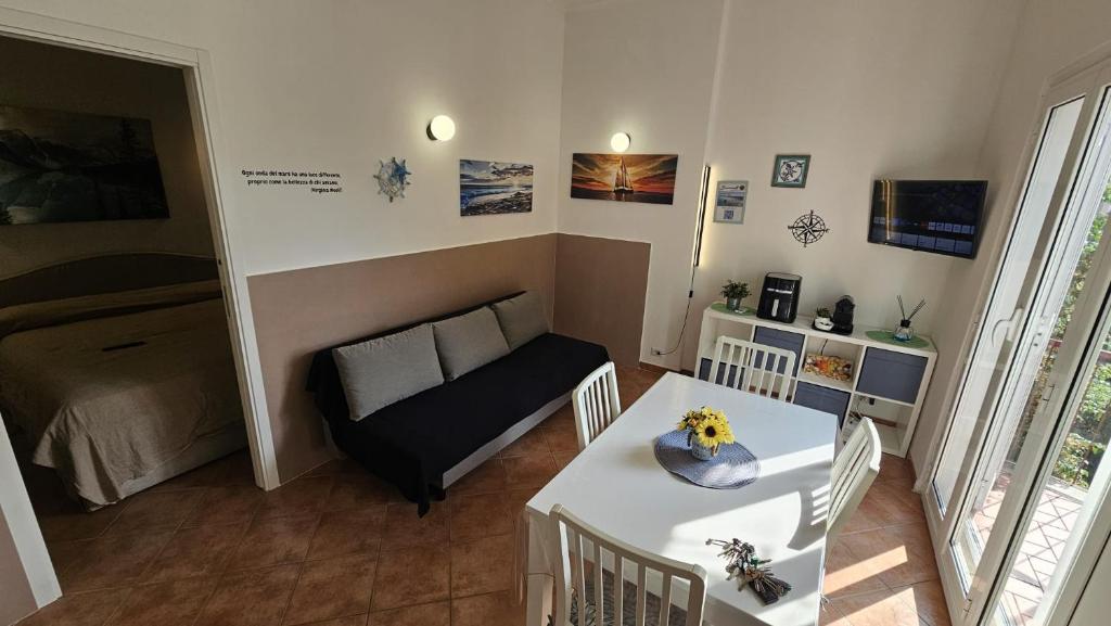 a small living room with a table and a couch at Stella Marina Apartment in Fregene