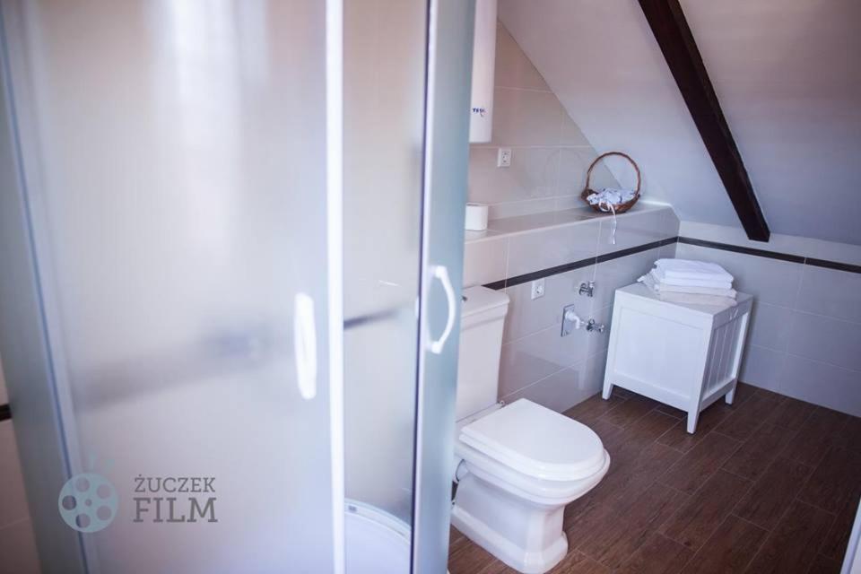 a white bathroom with a toilet and a shower at Villa Agava in Vrboska