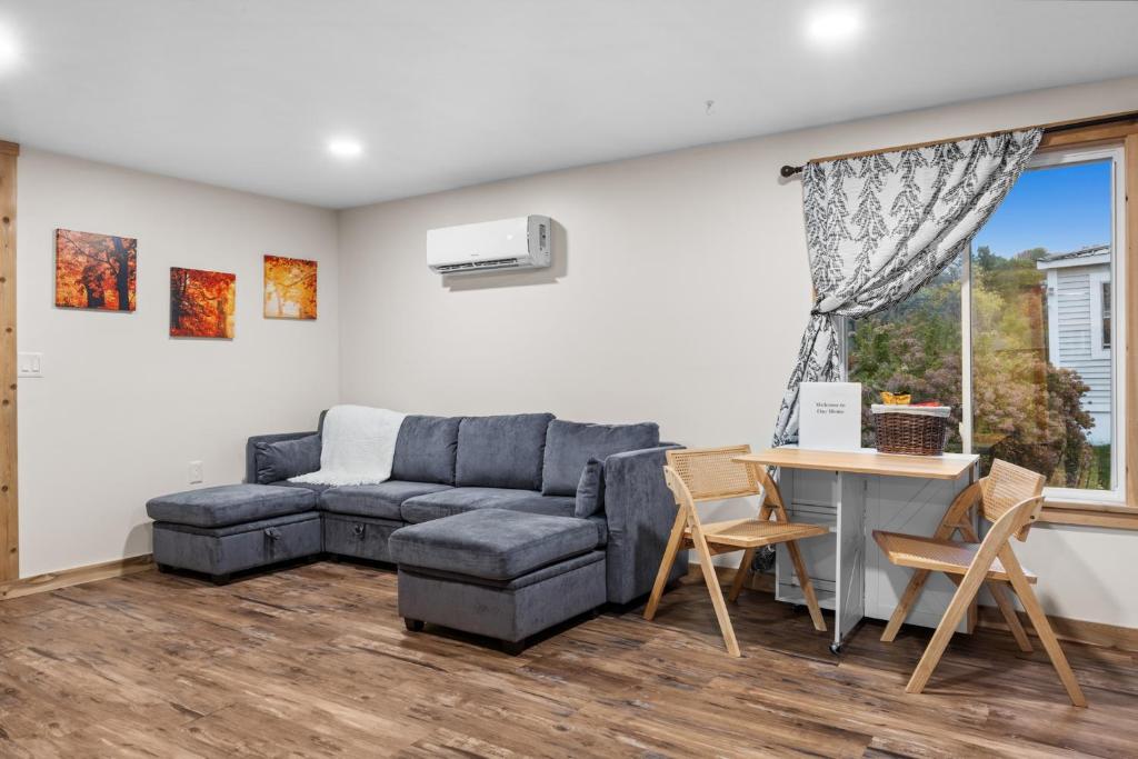 a living room with a couch and a table at Modern Home with Fast WiFi & Private Patio in Pittsfield